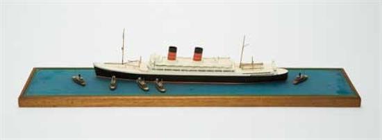 (CUNARD LINE.) "Mauretania" (II). Wonderful hand-crafted wooden model of the ship escorted by tugs, by VAN RYPER.